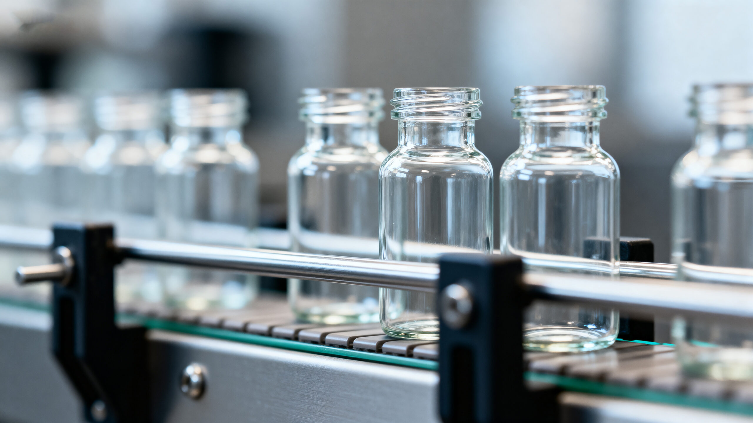 Klarglasflaschen in einer Produktionslinie, detektiert von wenglor-Sensoren.